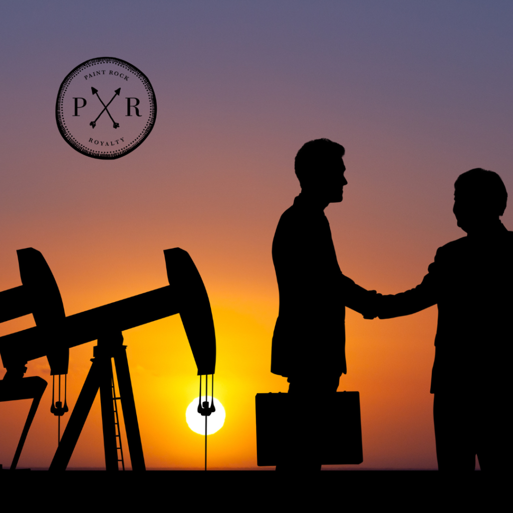 Silhouettes of two business professionals shaking hands in front of oil rigs at sunset with the PXR logo