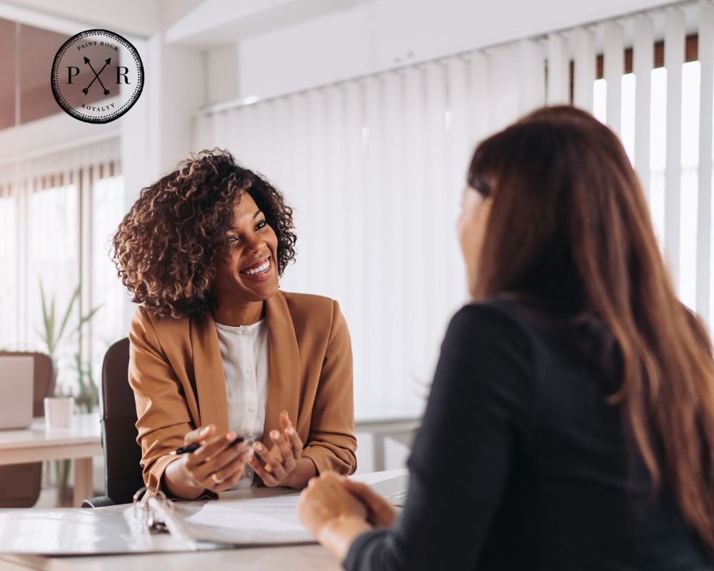 Two businesswomen having a professional discussion in an office setting.