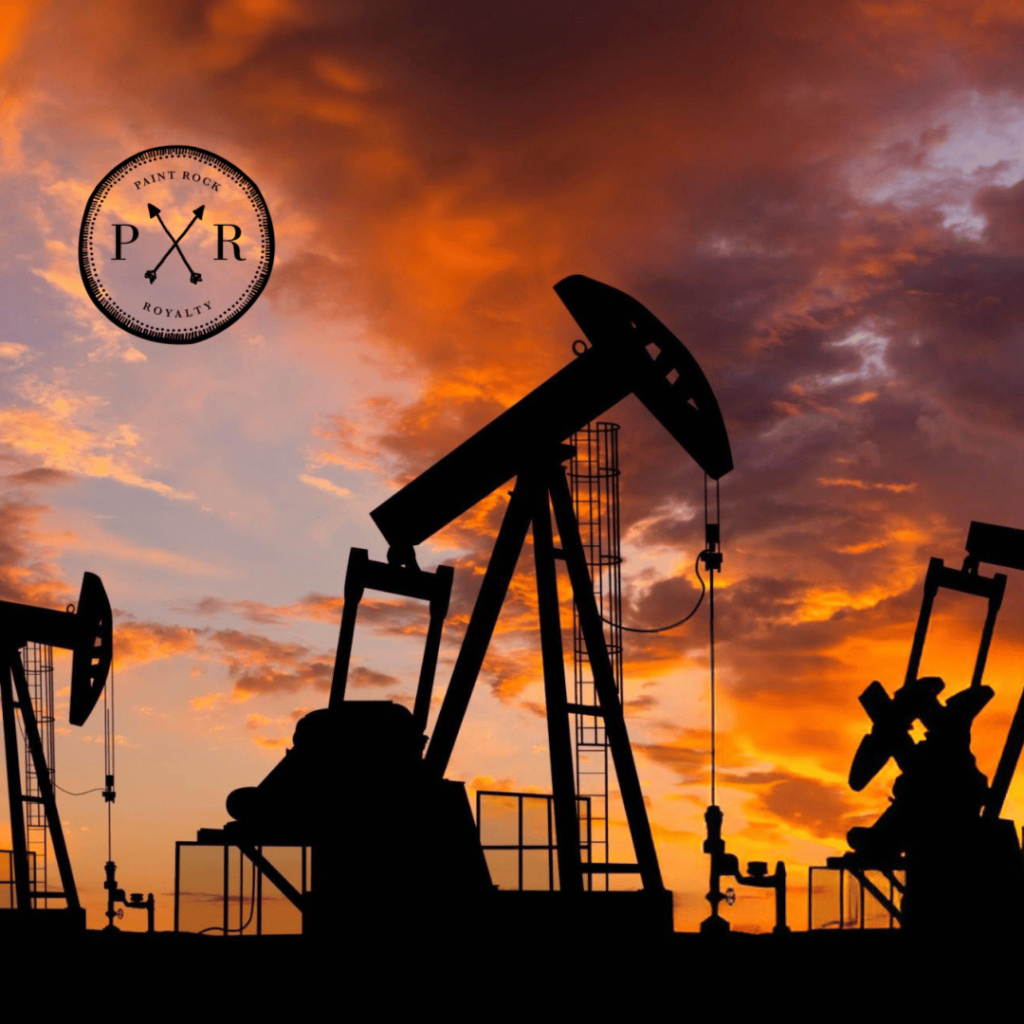 Multiple pumpjack oil rigs silhouetted against a dramatic sunset sky with the PXR logo.