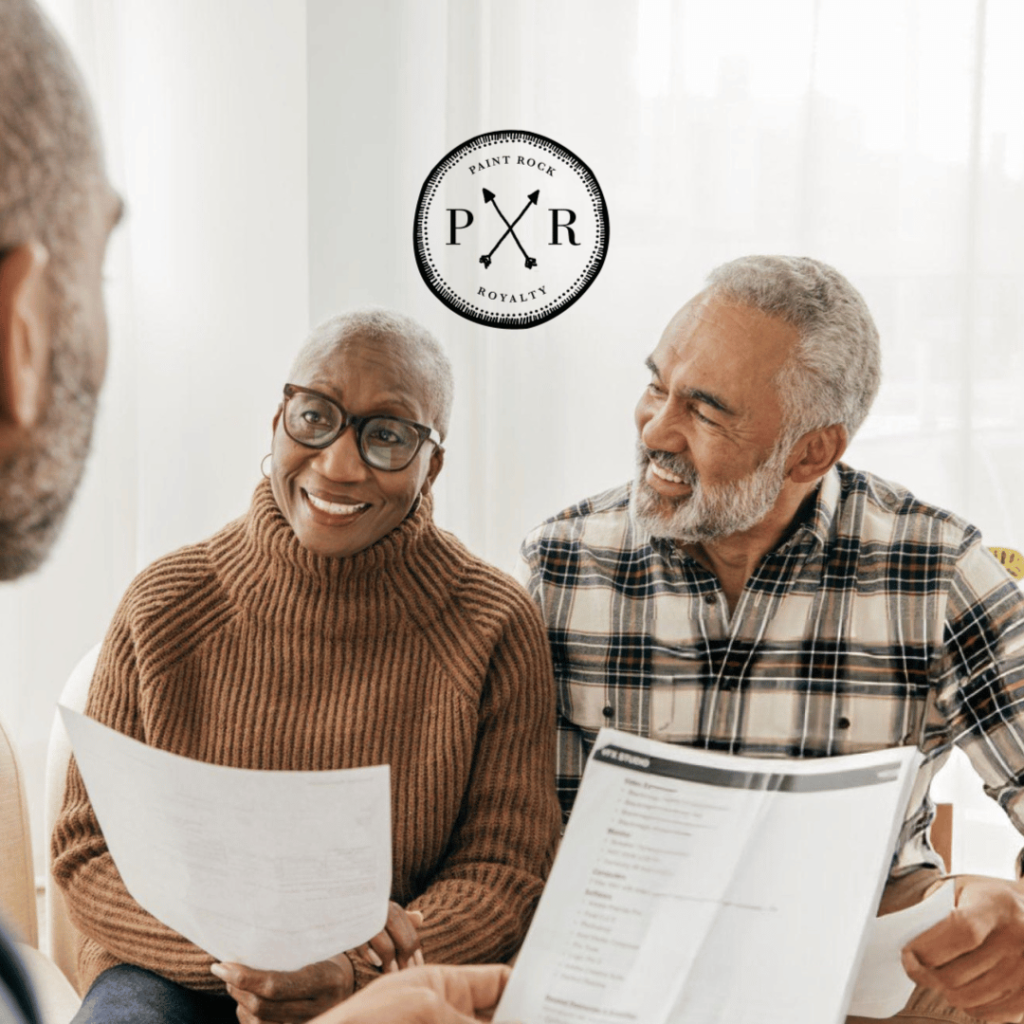 Happy senior couple reviewing financial documents with an advisor.