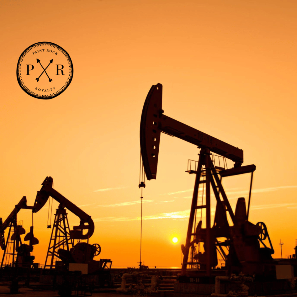 Silhouettes of pumpjack oil rigs against an orange sunset sky with the PXR logo.