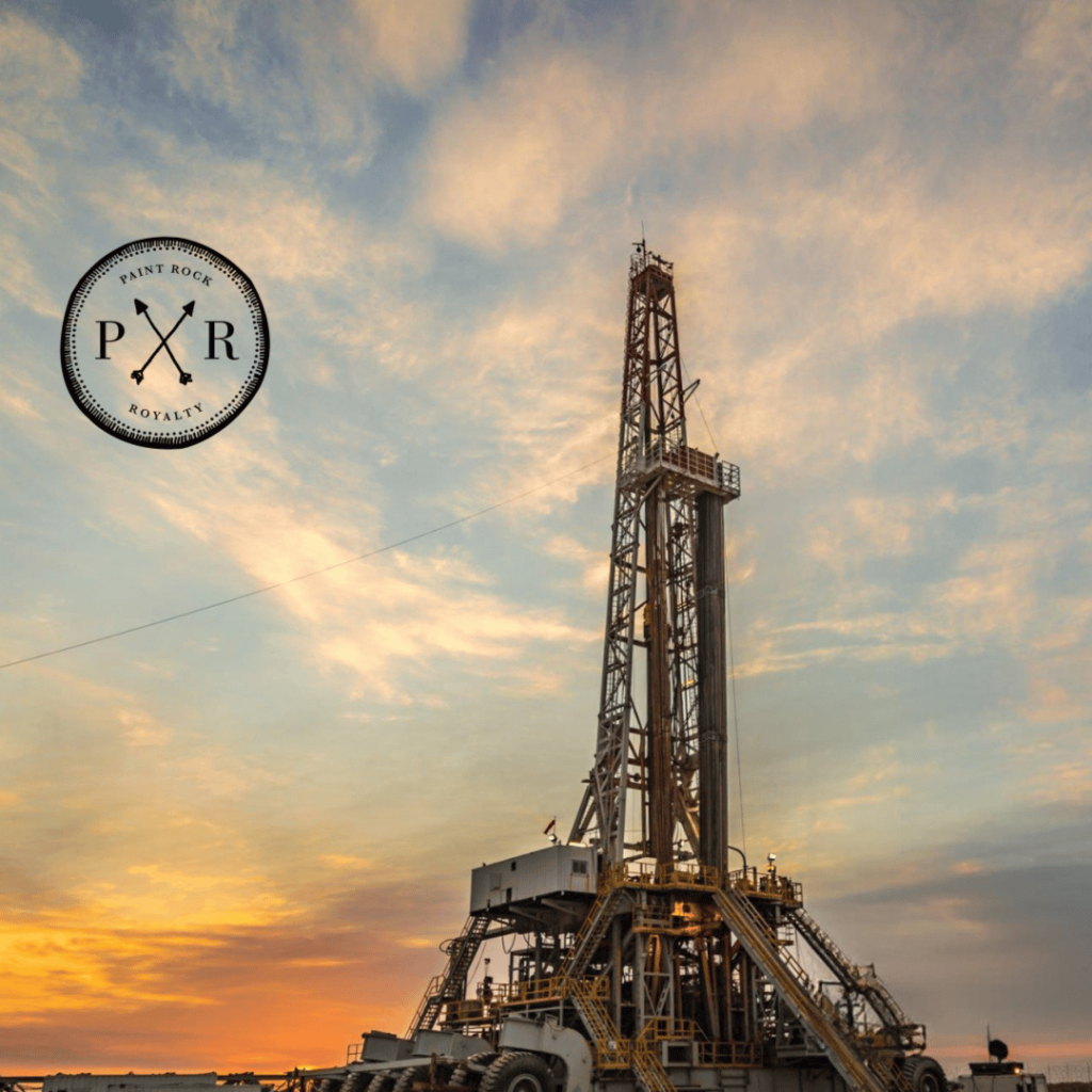 Oil drilling rig at sunset with the PXR logo in the top corner.