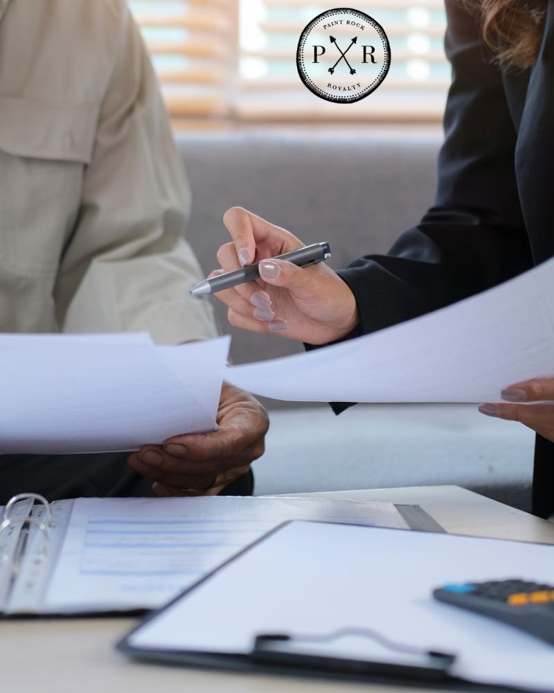 Close-up of professionals reviewing documents and signing agreements with the PXR logo.