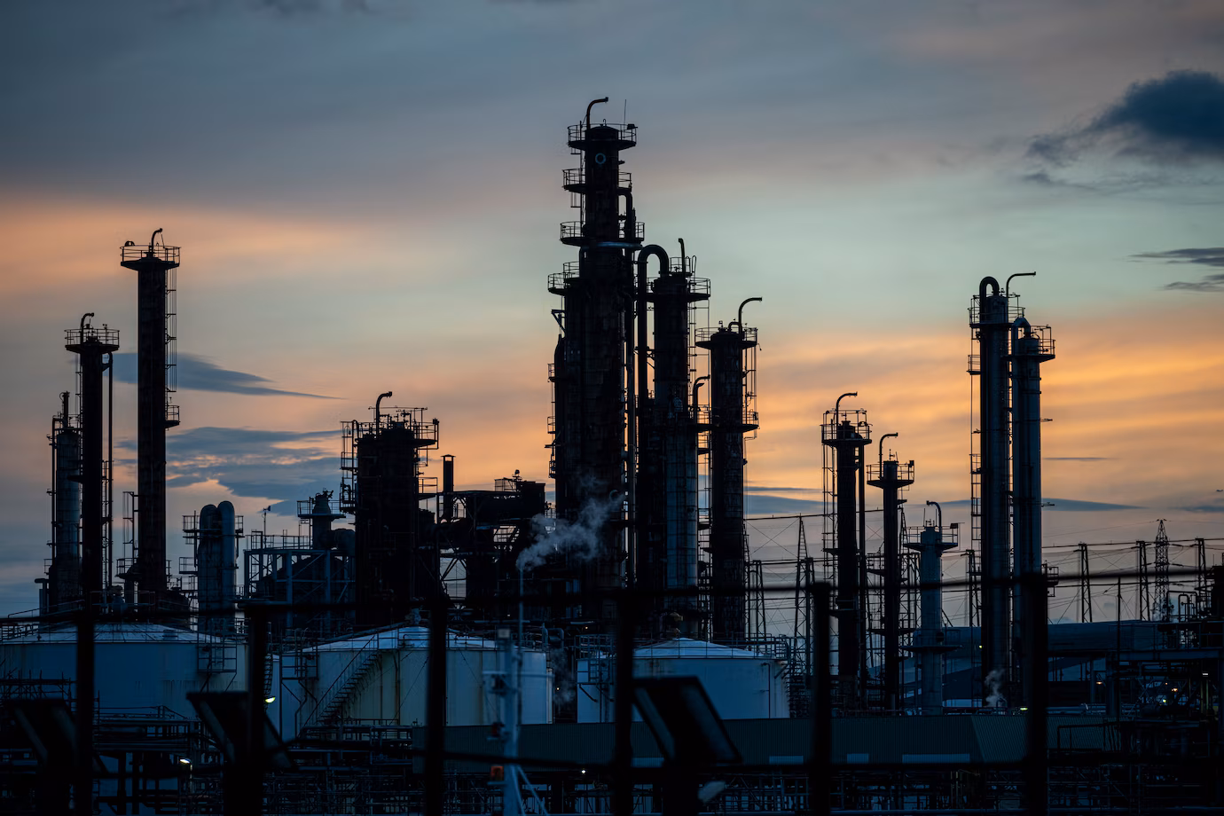 Industrial site with smoke emissions contributing to environmental pollution.