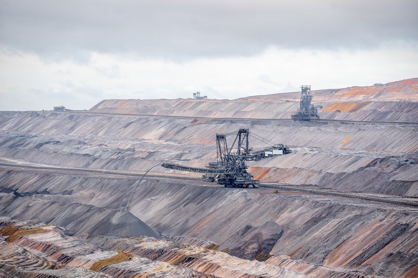 Wide-angle shot of excavation machines at Jackerath Garzweiler Skywalk, Germany, with an industrial landscape in the background.