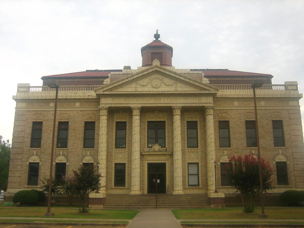 Historic Red River Parish Courthouse with neoclassical architecture and a symmetrical facade.