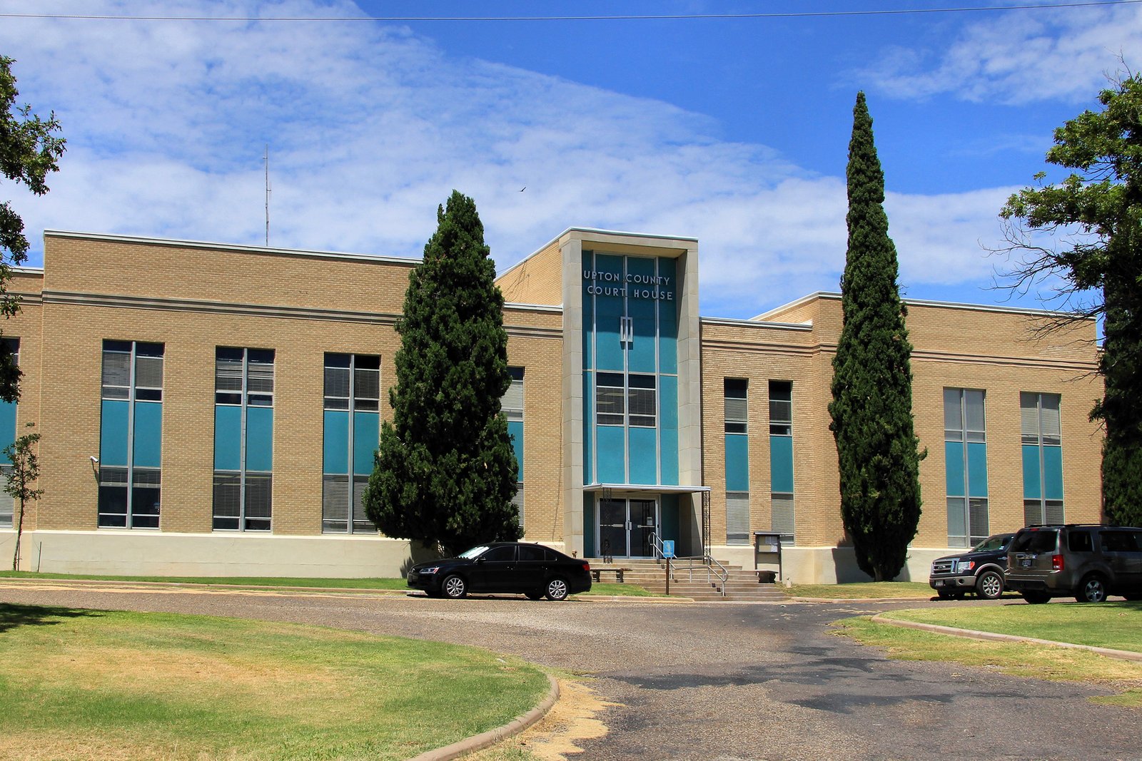 Upton County Courthouse, a mid-century modern courthouse with large blue windows and a simple architectural style.
